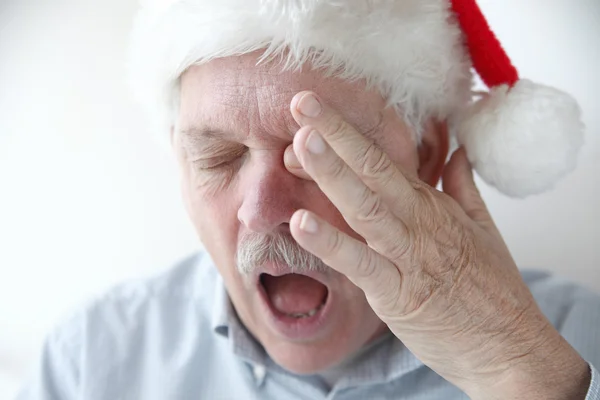 Tired man wearing Santa hat — Stock Photo, Image