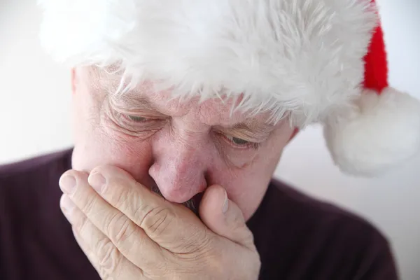 Senior in Santa hat has nausea — Stock Photo, Image