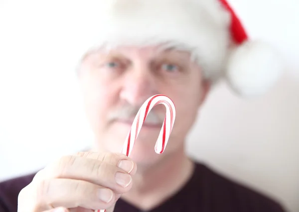 Older man with candy cane — Stock Photo, Image