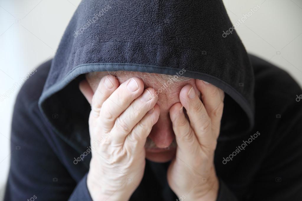 Man in black hoodie is depressed