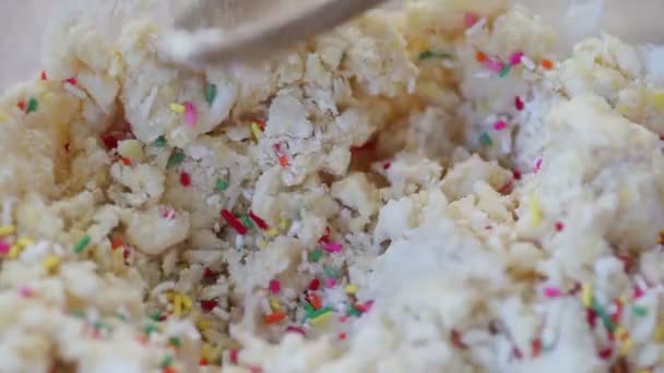 Woman Adds Colorful Sprinkles Batter — Stock Video