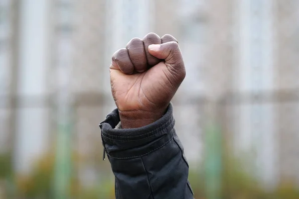 Raised black man fist in protest. Fist of african american, social justice and peaceful protesting racial injustice. Black Lives Matter, BLM. Mass protests against racism in USA