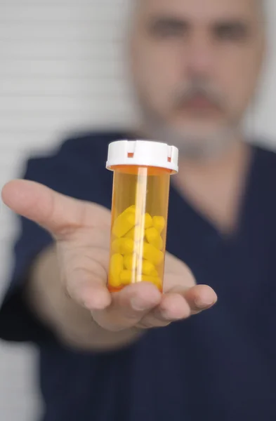 Nurse with pill bottle Royalty Free Stock Photos