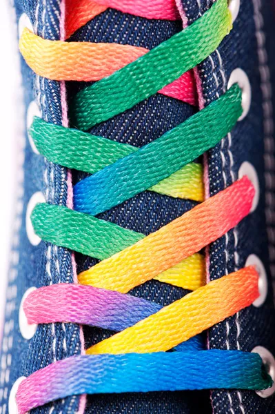 Closeup of a sneaker with colored shoelaces — Stock Photo, Image