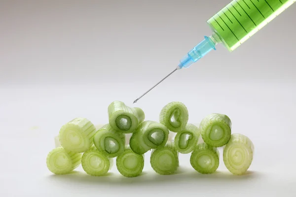 Injection into fresh young onion — Stock Photo, Image