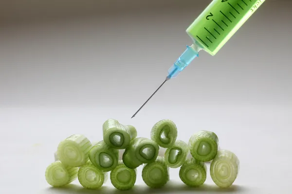 Injection into fresh young onion — Stock Photo, Image