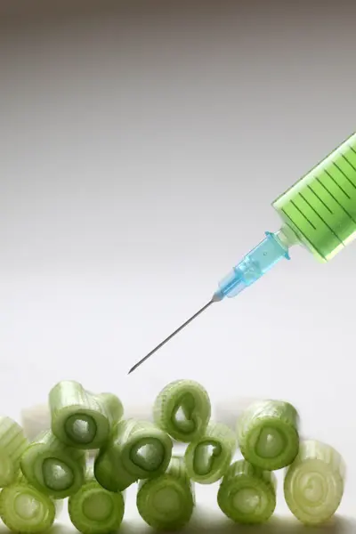 Injection into fresh young onion — Stock Photo, Image