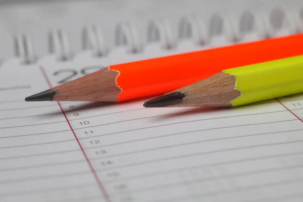 Pencils laying on notebook — Stock Photo, Image