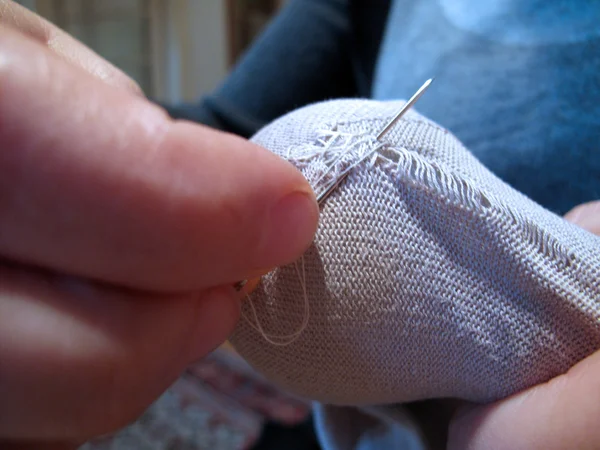 Crisis, mending socks — Stock Photo, Image