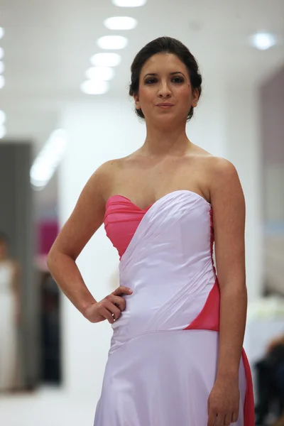 Fashion model in cocktail dress made by Miss B on 'Wedding Expo' show in the Westgate Shopping City in Zagreb, Croatia on October 12, 2013