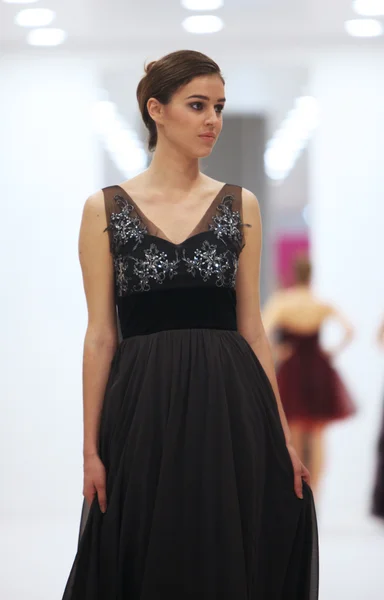 Fashion model in cocktail dress made by Ana Milani on 'Wedding Expo' show in the Westgate Shopping City in Zagreb, Croatia on October 12, 2013