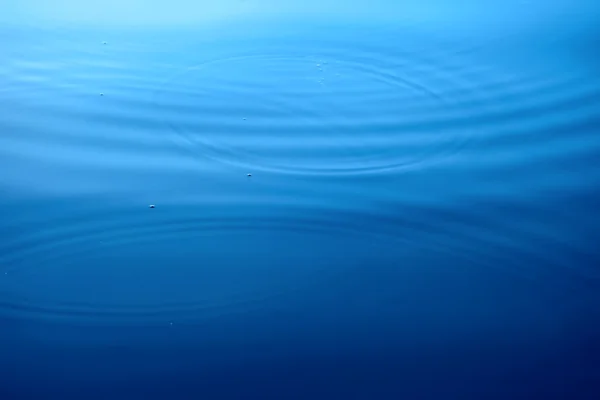 Círculos em uma superfície de água — Fotografia de Stock