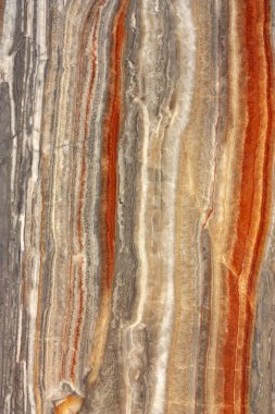Cross-section of the rock. Multi-colored layers that form an abstract background.