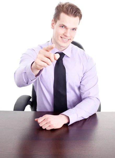 Young businessman sitting at desk and pointing at you — Stock Photo, Image