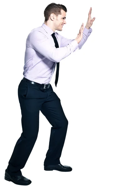 Young businessman pushing something - isolated on whit — Stock Photo, Image