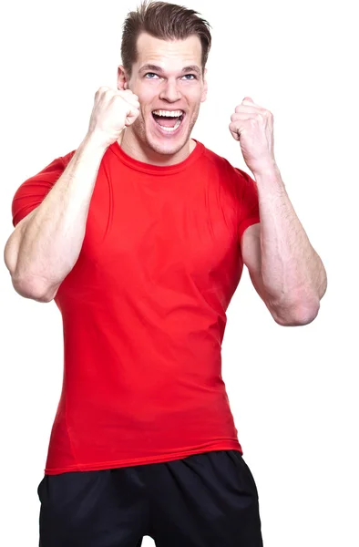 Happy young athlete raising his fists in excitemen — Stock Photo, Image