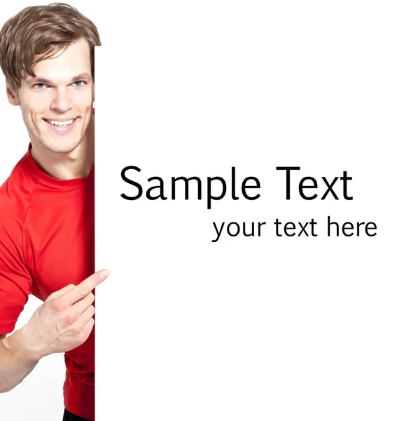 A happy smiling young man pointing at advertisement - much space — Stock Photo, Image