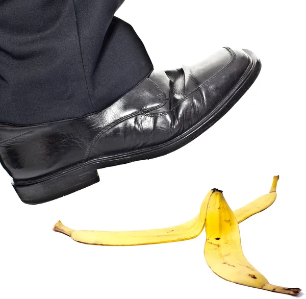 Closeup portrait of a business man foot stepping on banana pee — Stock Photo, Image