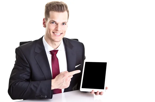 Handsome young businessman pointing at modern tablet compute — Stock Photo, Image