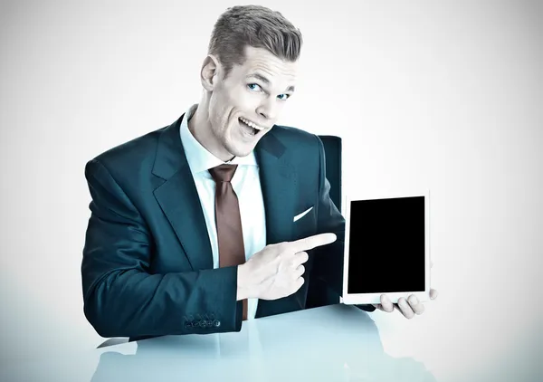 Funny businessman pointing at a modern tablet p — Stock Photo, Image