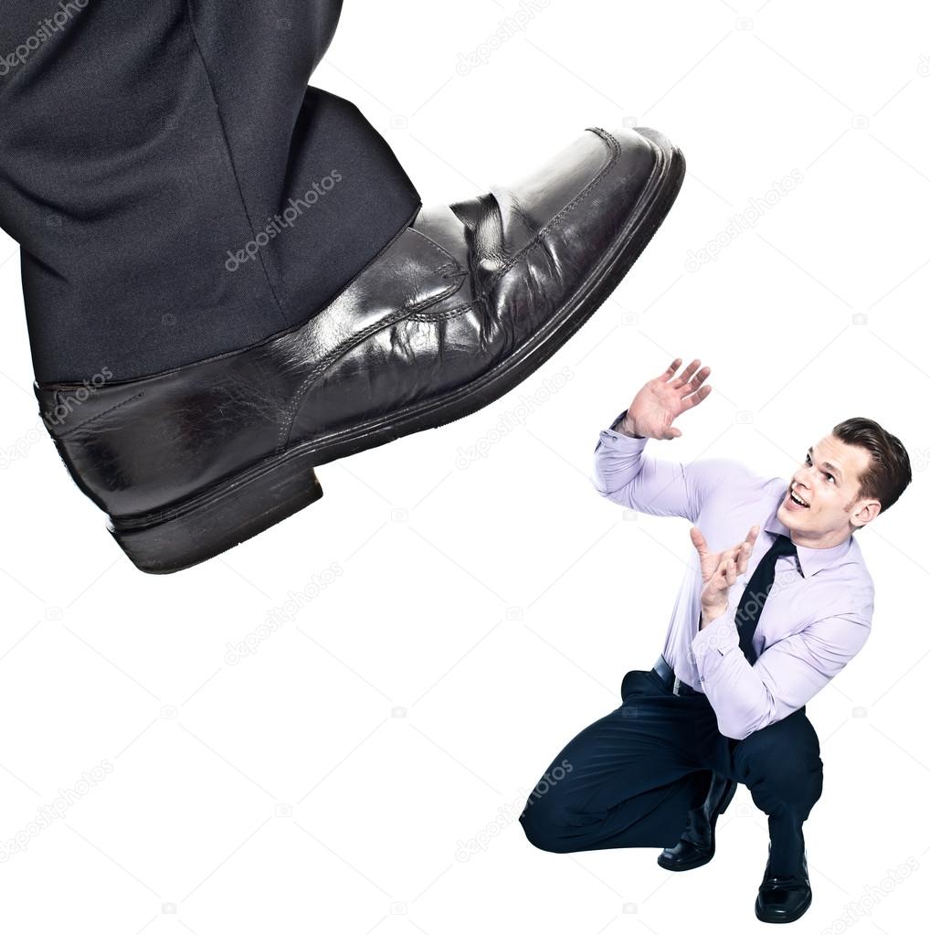 Businessman's foot stepping on tiny businessman - unequal compet