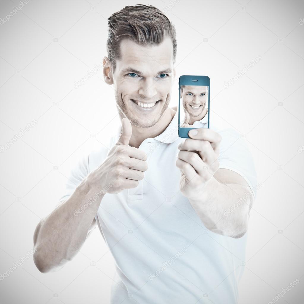 Cheerful young man taking a selfie with a modern smartphone