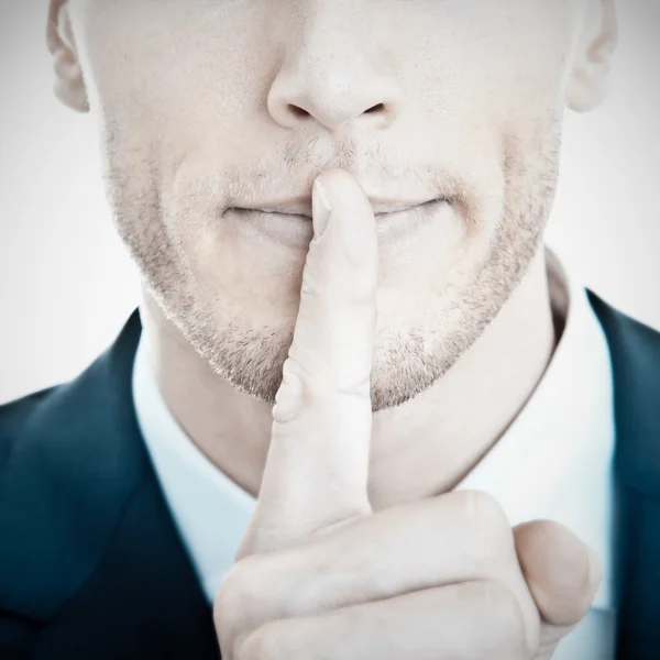 Top secret! - Young businessman with finger on his lips — Stock Photo, Image