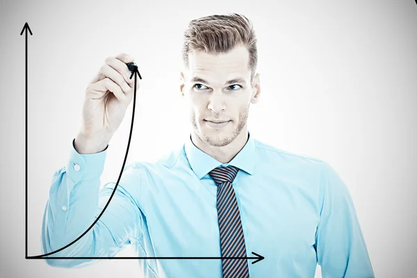 Growth - Young businessman draws an arrow onto a glass pane — Stock Photo, Image