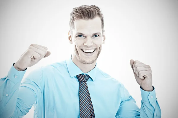 Young businessman with arms raised celebrating succes — Stock Photo, Image