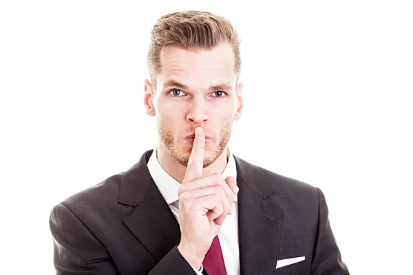 Topgeheim! -jonge zakenman met vinger op zijn lip — Stockfoto