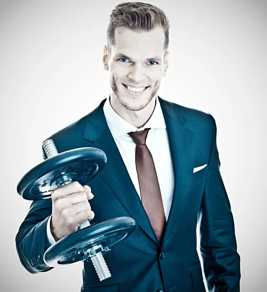 Motivation Concept - Young businessman lifting dumbbel — Stock Photo, Image