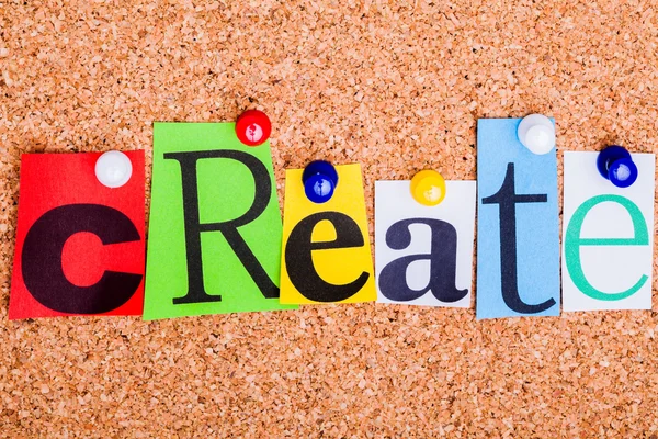 The word Create in cut out magazine letters pinned to a cork not — Stock Photo, Image