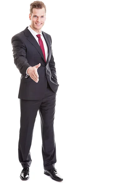 Portrait of a handsome businessman giving an handshake - full le — Stock Photo, Image