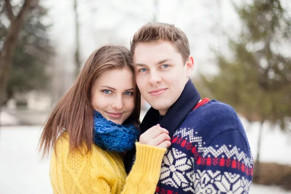 Portrait of a young happy couple in colored sweaters — Stock Photo, Image