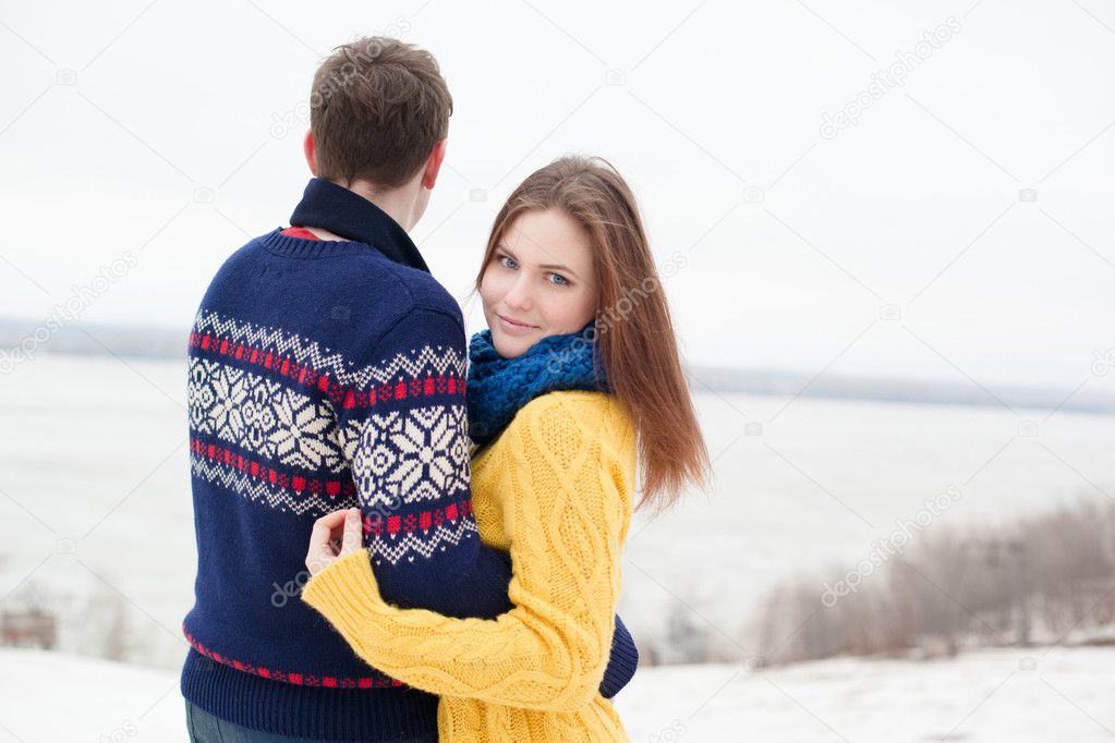 Portrait of a young happy couple in colored sweaters