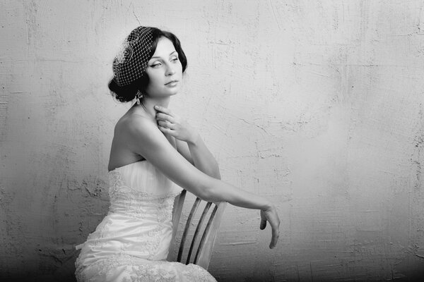 Beautiful young woman sits on a chair. Retro Style