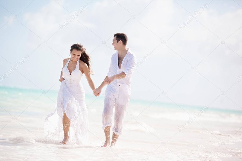 Newlywed Couple Running on a Tropical Beach