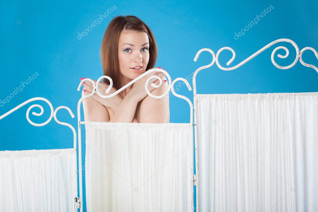 Girl changes clothes behind a screen