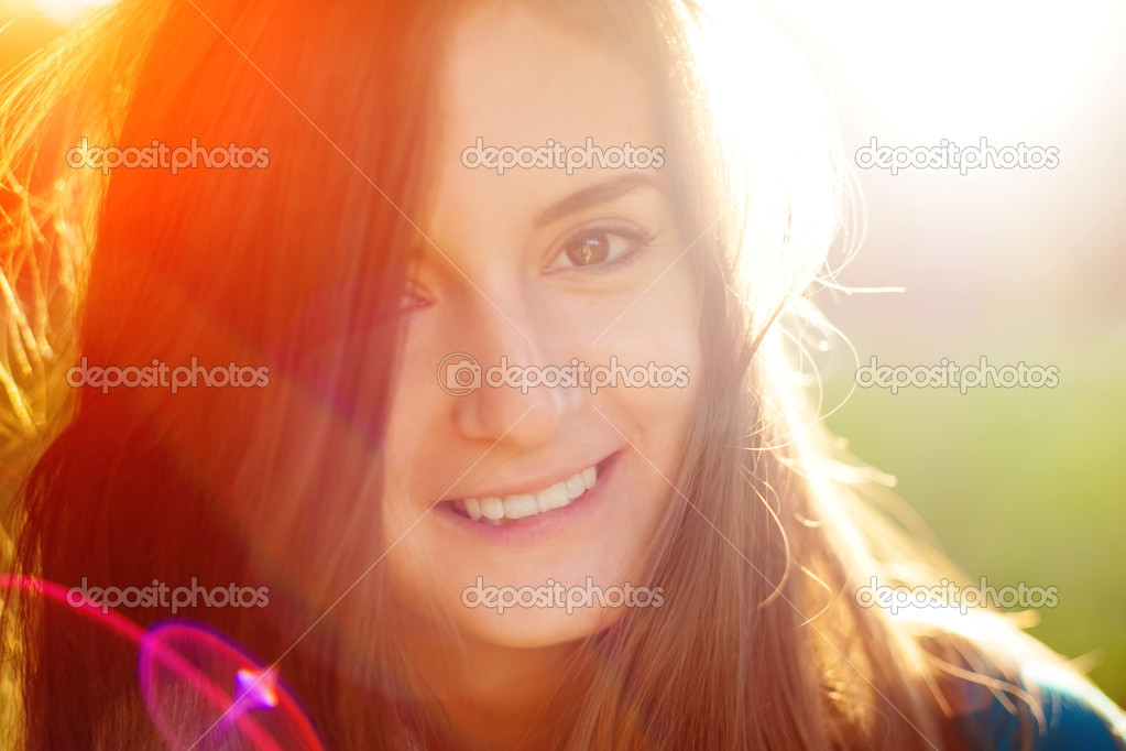 Portrait of a cute cheerful girl in the sunshine