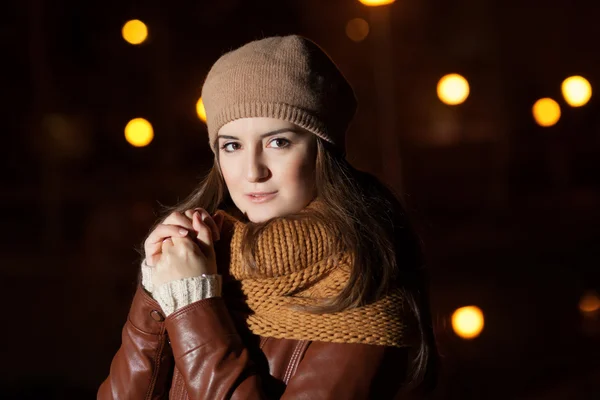 Retrato de uma menina em um lenço no fundo da cidade noturna — Fotografia de Stock