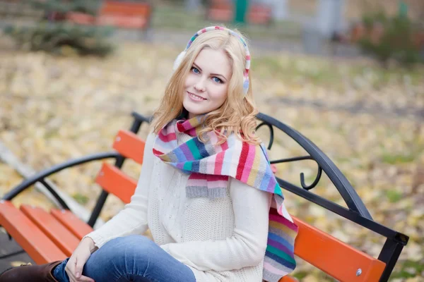 Pretty blond girl in a striped scarf — Stock Photo, Image