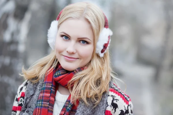 Söt blond tjej i päls hörlurar — Stockfoto