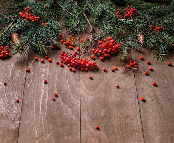 Christmas fir tree branches on a wooden board — Stock Photo, Image