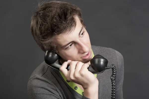 Young guy talking on the old phone — Stock Photo, Image