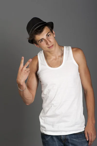 Young man in a white t-shirt with a black hat — Stock Photo, Image