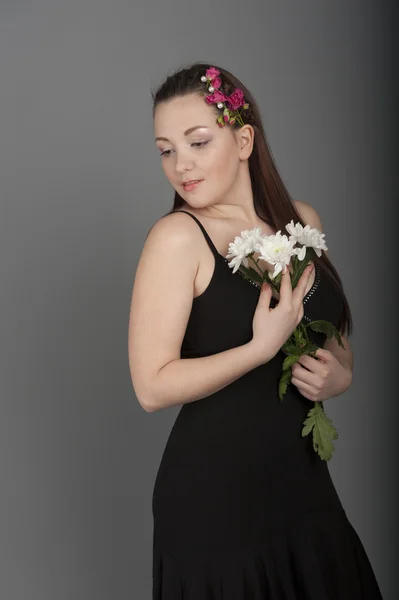 Young woman in a dark dress — Stock Photo, Image