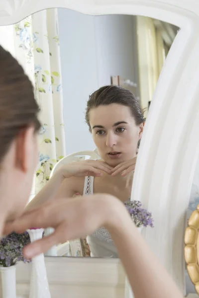 Portrait of a young woman at the mirror — Stock Photo, Image