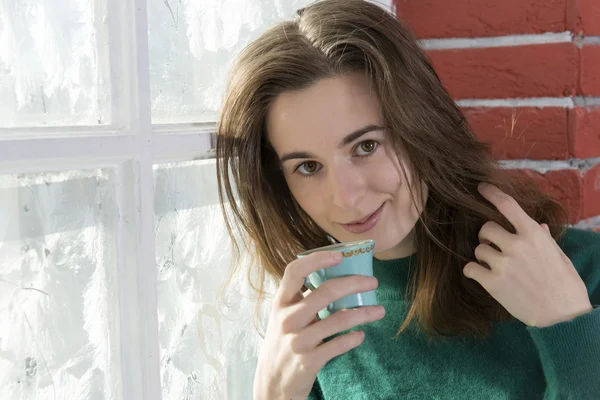 Young woman at the winter window — Stock Photo, Image