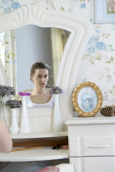 Portrait of a young woman at the mirror — Stock Photo, Image