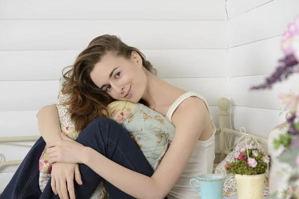Young woman in the children's room on the bed — Stock Photo, Image